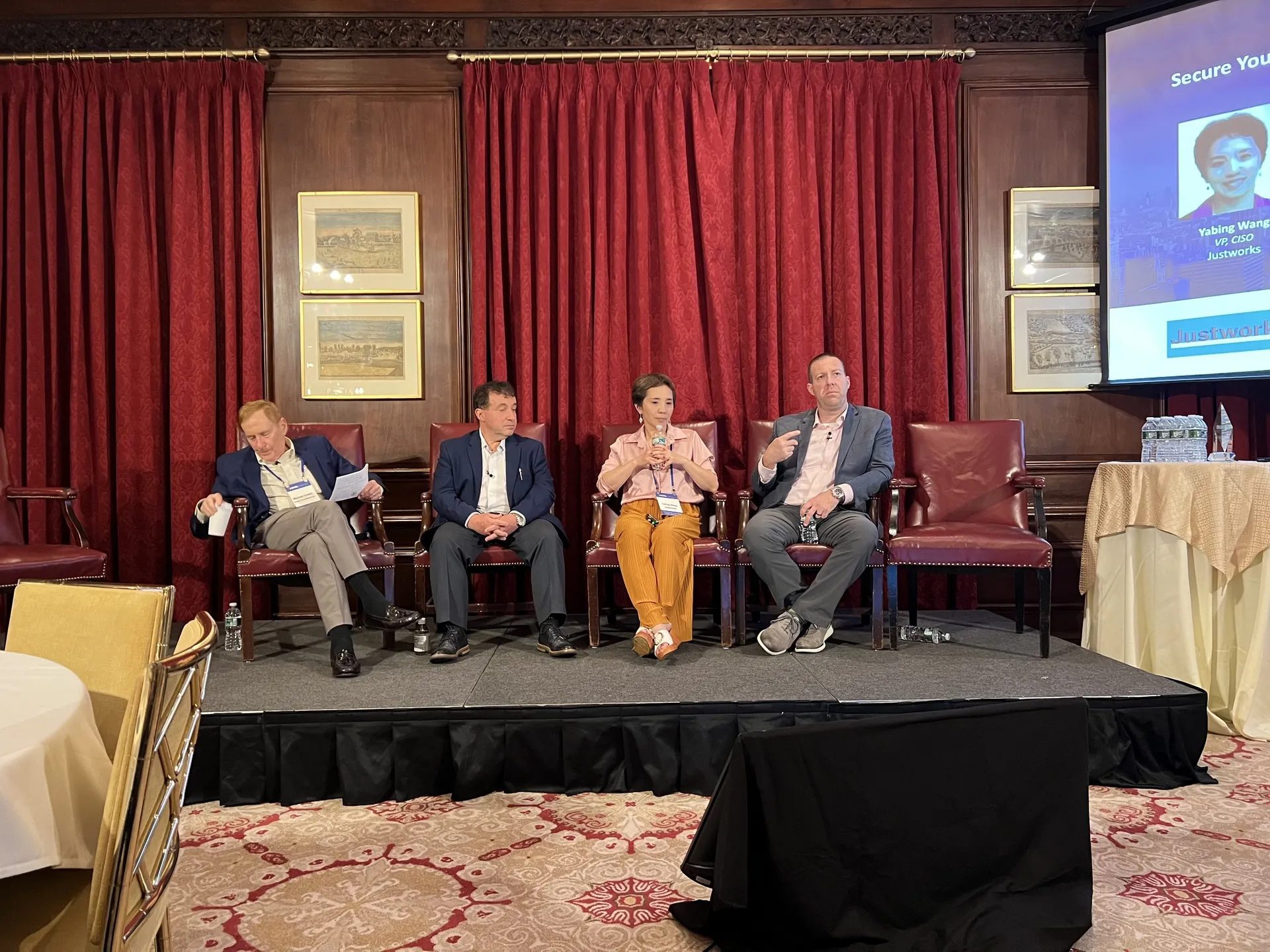 Dan Gorecki speaking on a four-person executive panel